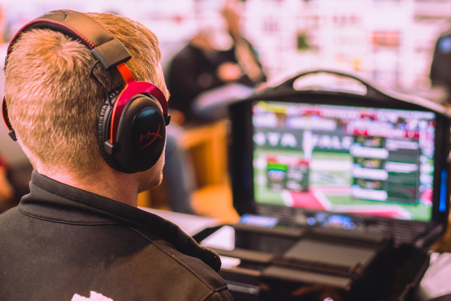 Man-with-Gaming-Headphones-on-Laptop.